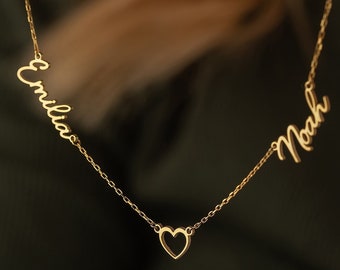May include: Gold necklace with two names, "Emilia" and "Noah", connected by a heart charm.