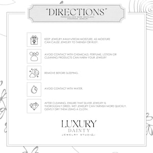 May include: A white card with the title "DIRECTIONS" and instructions for jewelry care. The card includes icons and text advising to avoid moisture, chemicals, and water, and to remove jewelry before sleeping. The card also recommends drying silver jewelry after cleaning. The brand name "LUXURY DAINTY JEWELRY STUDIO" is at the bottom.