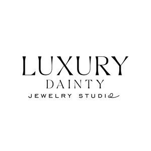 May include: Luxury Dainty Jewelry Studio logo with a cursive font. The logo is black and white.