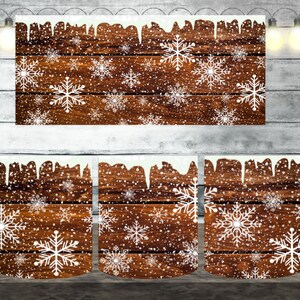 May include: Three white ceramic mugs with a winter-themed design. The mugs feature a brown woodgrain background with white snowflakes and a white icicle design at the top.