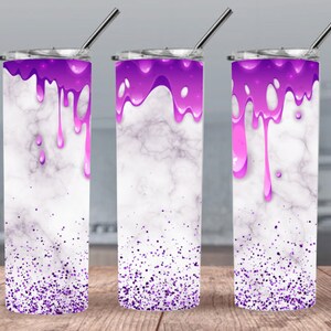 May include: Three stainless steel tumblers with lids and straws. The tumblers are white with a marble pattern and purple glitter. The top of each tumbler is filled with a purple liquid that is dripping down the sides.
