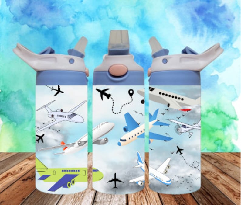 May include: Three blue and white water bottles with a variety of airplane designs. The bottles have a white lid with a blue spout and a blue handle.