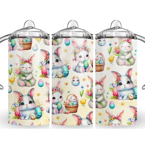 May include: Three stainless steel sippy cups with a repeating pattern of Easter bunnies, eggs, and flowers. The bunnies are white and gray with floral crowns, holding eggs and bouquets. The background is a light yellow.