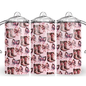 May include: Three baby bottles with handles, each featuring a pink background adorned with a pattern of cowboy boots, bows, and floral accents. The bottles have clear tops and silver handles.