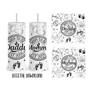 May include: A white marble-effect tumbler featuring the text "SOON TO BE Daddi EST. 2026" and "SOON TO BE Momm EST. 2026". The design includes baby footprints and other baby-themed graphics. The words "DIGITAL DOWNLOAD" are at the bottom.
