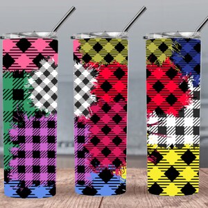 May include: Three stainless steel tumblers with colorful plaid patterns and paint splatters. The tumblers are all the same size and shape, but each has a different color scheme. The first tumbler is pink, green, and blue. The second tumbler is yellow, red, and blue. The third tumbler is red, black, and yellow.