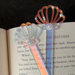 May include: A set of three ceramic mugs with a speckled, matte finish. The mugs are in shades of cream, light grey, and dark grey. Each mug has a simple, minimalist design, ideal for coffee or tea.