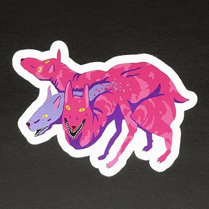 May include: A sticker featuring a pink, purple, and yellow three-headed dog with a snarling expression. The dog is depicted in a dynamic pose, with its heads and bodies intertwined.