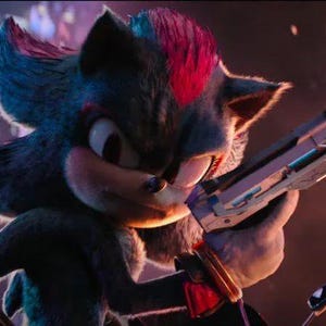 May include: A dark-furred anthropomorphic hedgehog character with red highlights on the head, large eyes, and sharp quills. The character is holding a metallic, futuristic-looking firearm in a forward-facing stance with a focused expression.