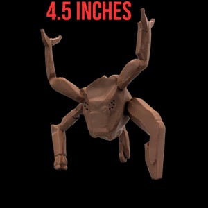 May include: A brown, insect-like sculpture with six articulated limbs and a segmented body. The sculpture is 4.5 inches in height and is set against a black background. The text "4.5 INCHES" is displayed in red above the sculpture.