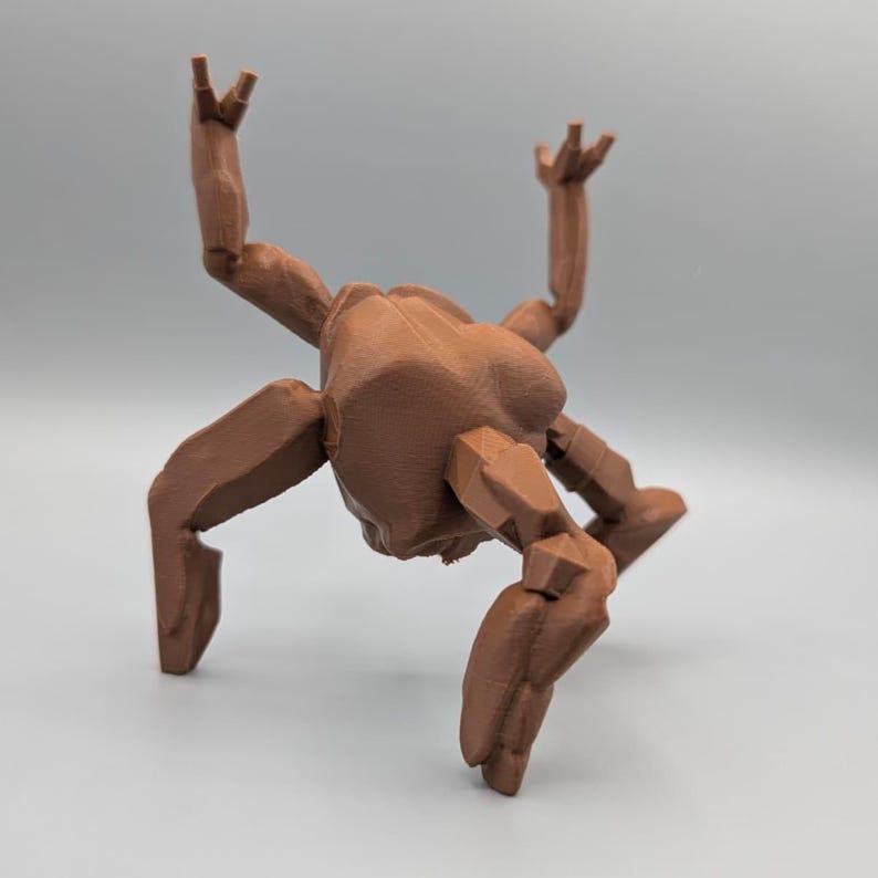 May include: A brown, 3D-printed articulated figure with a stylized, geometric design. The figure has multiple limbs and is posed with its arms raised and legs bent, giving it a dynamic appearance. The figure is made of a solid brown material.