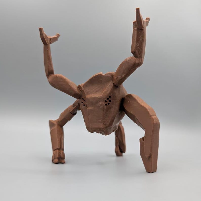 May include: A brown, geometric sculpture of a creature with multiple limbs and a head with several small holes. The sculpture has a stylized, angular design and is posed as if it is walking or crawling.