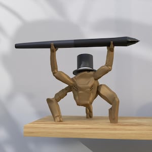 May include: A brown, stylized insect-like sculpture wearing a top hat, holding a black pen aloft. The sculpture is on a wooden shelf. The pen is approximately 12 inches long.