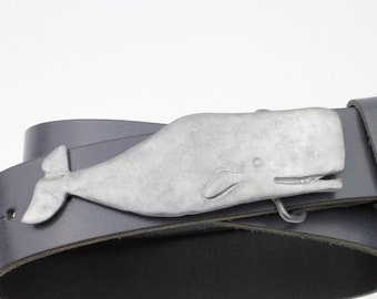 May include: A black leather belt with a silver whale buckle. The whale is detailed with a textured surface and a small eye.