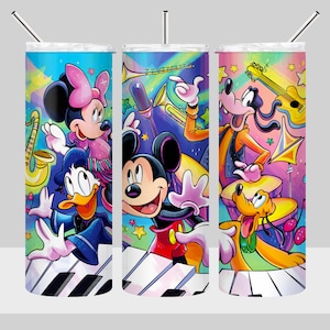 May include: A set of three stainless steel tumblers with a colorful illustration of Mickey Mouse, Minnie Mouse, Donald Duck, Goofy, and Pluto playing musical instruments. The background features a rainbow, stars, and a piano keyboard.