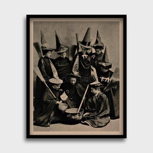 May include: A vintage black and white photograph of a group of women dressed as witches, gathered around a cauldron. They are wearing pointed hats and long robes, and some are holding brooms.