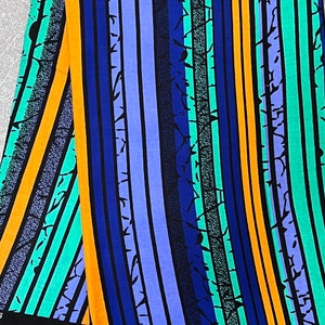 Puede incluir: Tela a rayas con un esquema de color azul, verde, naranja y negro. La tela tiene un patr&oacute;n texturizado con un dise&ntilde;o agrietado o roto.