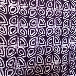 May include: Purple fabric with a white pattern of overlapping circles and ovals.