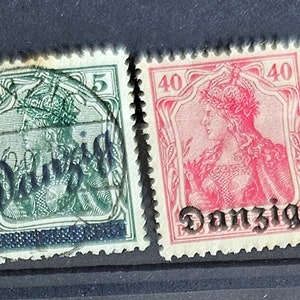 May include: Six vintage postage stamps from Danzig, Germany. The stamps feature a portrait of a woman in a crown and the word "Danzig" printed in black.