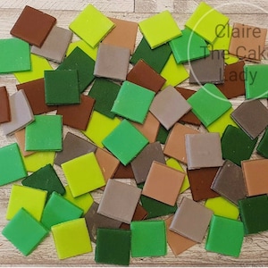May include: Assortment of green, brown, and grey fondant squares. The squares are arranged in a random pattern. The fondant squares are perfect for decorating cakes and cupcakes.