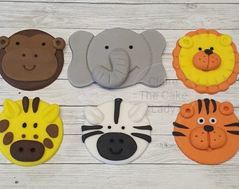 May include: Six colorful fondant animal cupcake toppers. The toppers feature a monkey, elephant, lion, giraffe, zebra, and tiger. Each topper is approximately 2 inches in diameter.