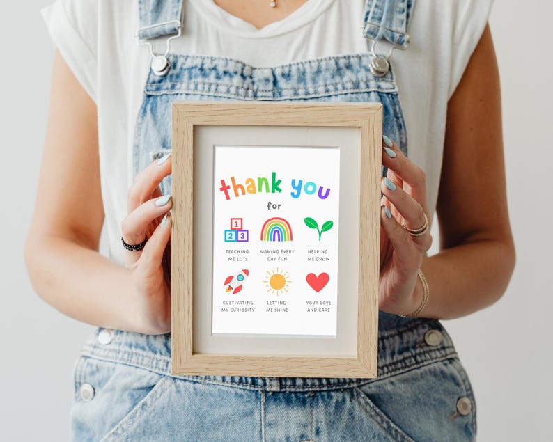 teacher holding a framed thank you gift