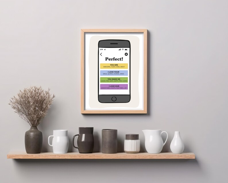 May include: A framed print featuring a smartphone illustration with the text Perfect! followed by four colored bars containing the phrases YOU ARE, I LOVE YOUR, YOU MAKE ME, and I LOVE OUR, each with smaller descriptive words listed below.