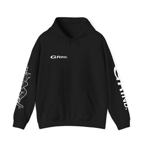 May include: Black hoodie with a white graphic on the front that says "GRIND." The sleeves have a white graphic of a person skateboarding.