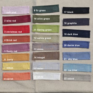 May include: A collection of 23 rectangular fabric swatches in various colors, including soft pink, wine red, and fir green. Each swatch is labeled with a number and color name, such as "1 soft pink" and "17 black."