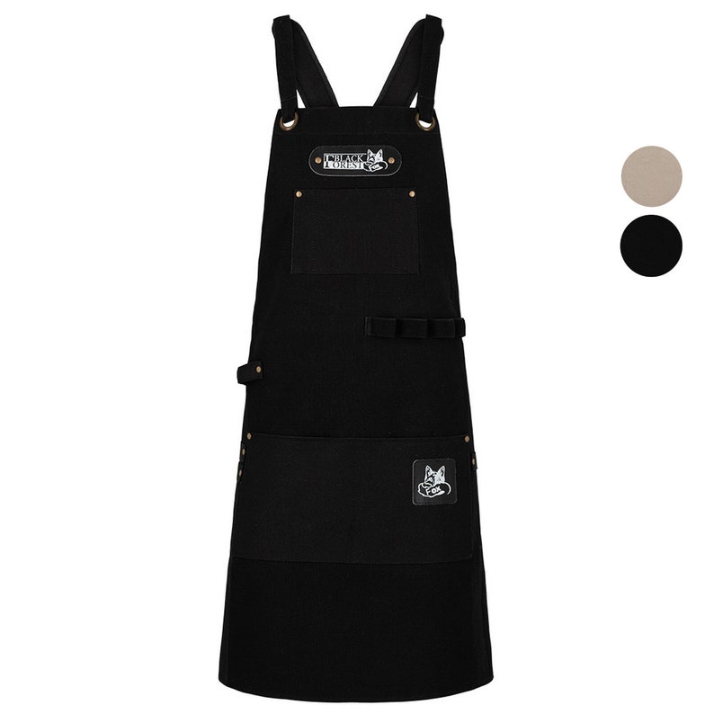 May include: Black canvas apron with adjustable straps, a large pocket, and a smaller pocket with a fox logo. The apron has a brown leather patch with the text "Black Forest" on it.