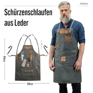 May include: A gray canvas apron with leather accents and multiple pockets. The apron has a variety of tools attached to it, including tongs, a spatula, a whisk, and scissors. The apron is 68 cm wide and 84 cm tall.