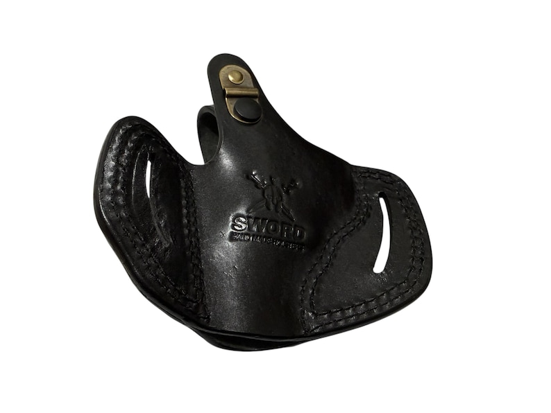 May include: Black leather holster with a stitched design and a brass-colored clasp. The word "SWORD" is embossed on the front. The holster has two openings and a curved shape.
