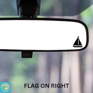 May include: A rearview mirror with a black sailboat silhouette sticker on the right side. The text "FLAG ON RIGHT" is visible below the mirror.