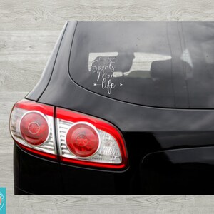 May include: A black car with a white vinyl decal on the back window that reads "I'm that Sports Mom - life".