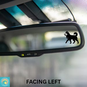 May include: Black silhouette of a dog decal on a car's rearview mirror. The decal is facing left. The text "FACING LEFT" is at the bottom of the image.