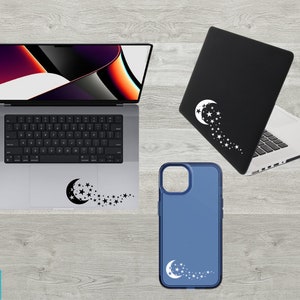 May include: Three different devices with a crescent moon and stars design. A laptop, a phone case, and a laptop skin all feature the same design.