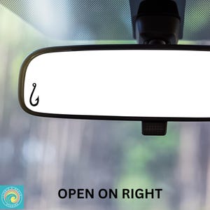 May include: A white rearview mirror with a black fishing hook decal on the left side. The text "OPEN ON RIGHT" is visible below the mirror.