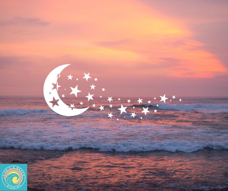 May include: A white crescent moon with stars trailing behind it, set against a pink and orange sunset over a blue ocean.
