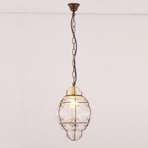 May include: A hanging pendant light with a clear, textured glass globe encased in a dark metal frame. The light fixture is suspended from a chain and ceiling mount, creating a vintage or antique aesthetic.