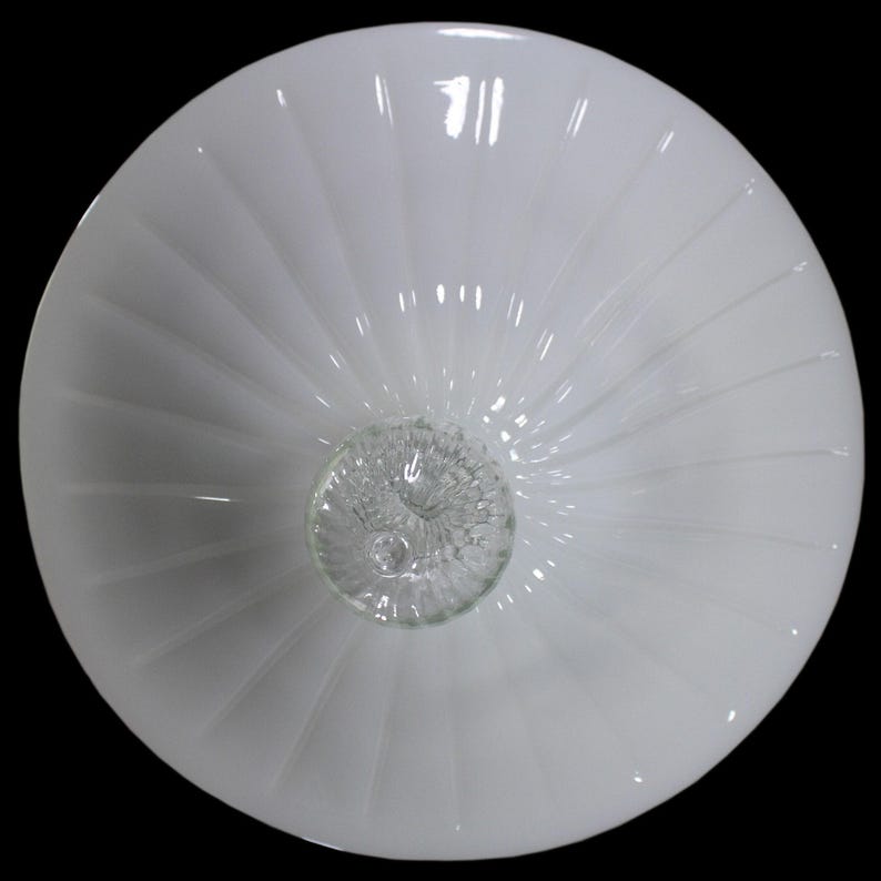 A white, round bowl with a spiral pattern on its surface.