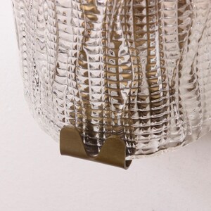 a close-up view of a glass surface with a metallic, curved piece attached to it.