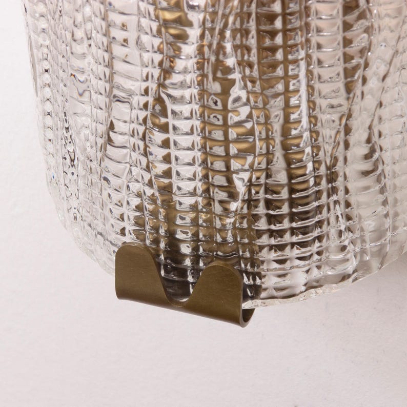 a close-up view of a glass surface with a metallic, curved piece attached to it.
