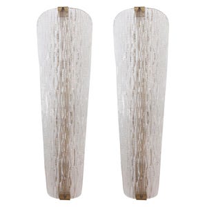 two tall, clear glass lamps with a textured, woven pattern.