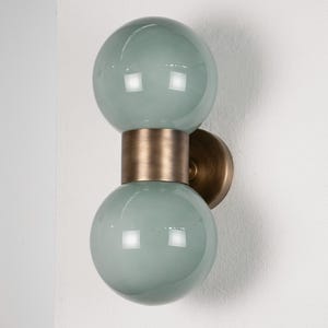 Wall sconce with green Murano glossy glass sphere with antique brass frame, handmade lamps Made in Italy