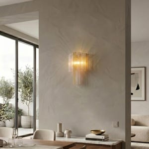 a modern and minimalist living space with a large window, a wall-mounted light fixture, and a dining table with chairs.