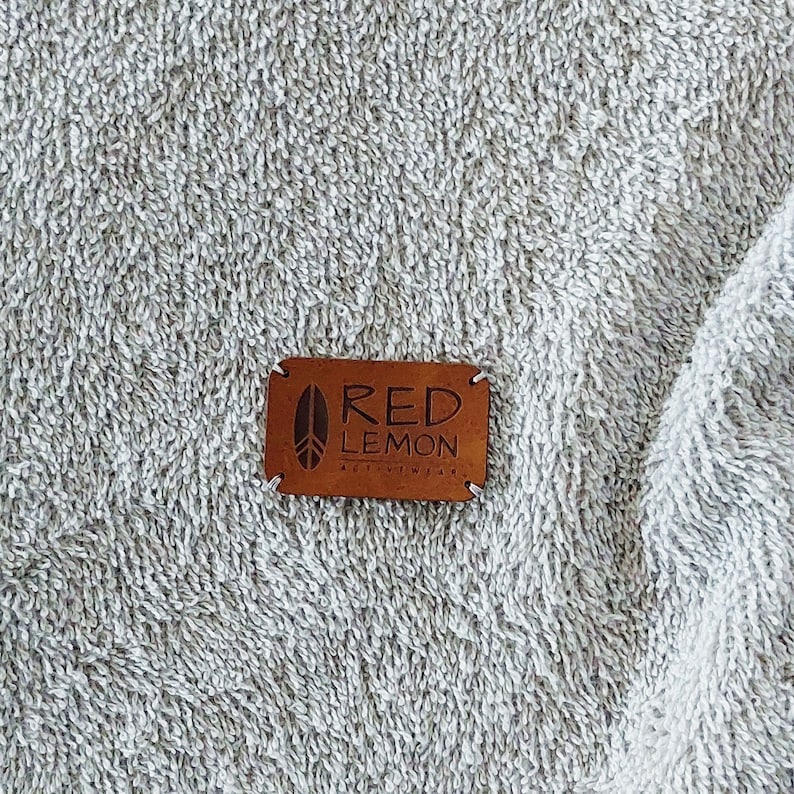 May include: A brown leather patch with the text "RED LEMON ACTIVEWEAR" in white lettering.
