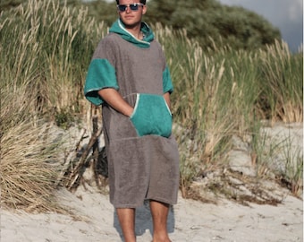 May include: A gray hooded towel robe with a teal pocket and trim. The robe is made of soft, absorbent material and is perfect for changing after swimming or surfing.
