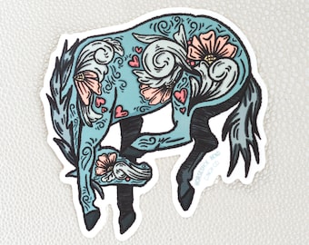 May include: A blue horse sticker with floral and heart designs. The sticker has a black outline and the text "HORSEBACK BEND CINCH CO." at the bottom.