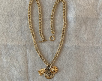 Vintage Anne Klein 32 Inch Textured Gold Tone Runway Neckace with Lion Coin, Lion Face, and Tassel and a Toggle Clasp