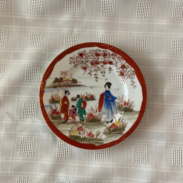 Vintage Hand Painted Geisha Porcelain 6 inch Japanese Plate with rust-red and gold trim and painted scene.